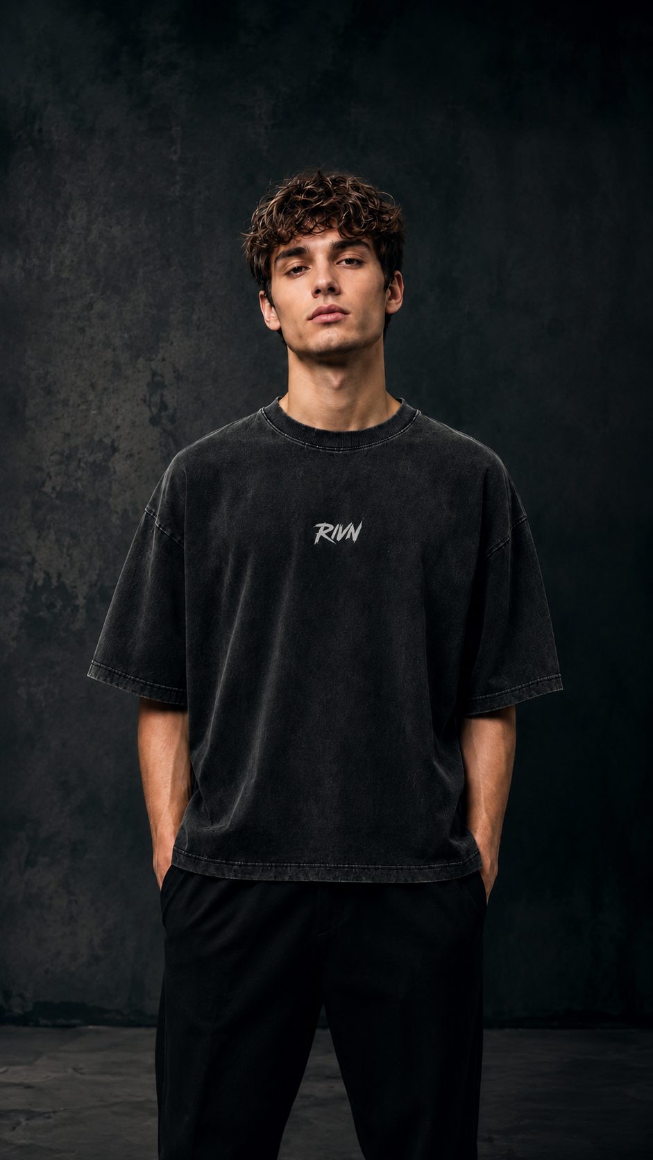 First Cut heavyweight boxy tee, washed matte black, worn front view — RIVN FC-001